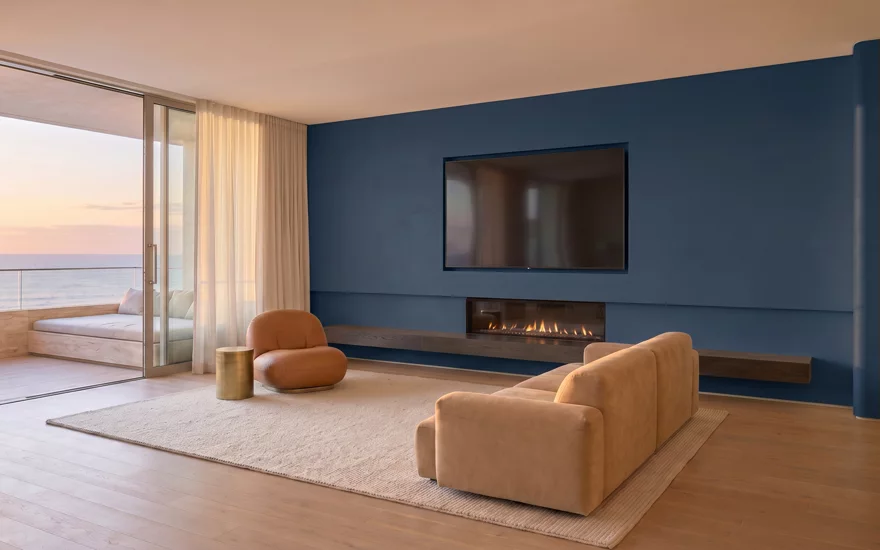 The same wall painted deep navy, the furniture restyled to match